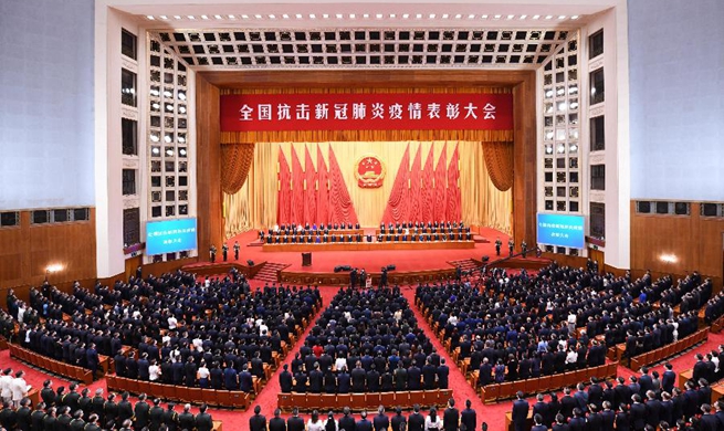 China holds meeting to commend COVID-19 fight role models