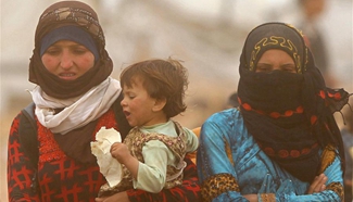 Refugees wait to cross Jordan-Syria border